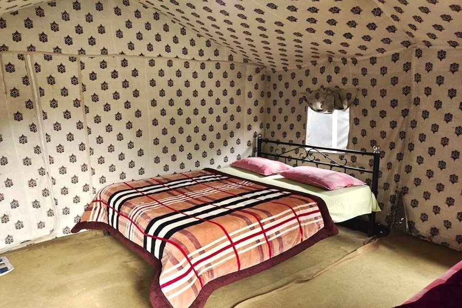 Cozy camp interior with neatly arranged bedding at camp majestic