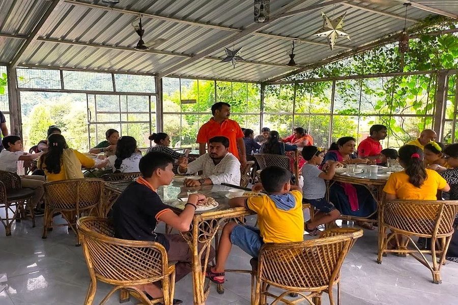 Group of children sitting together in a dining area having their meal in camp majestic